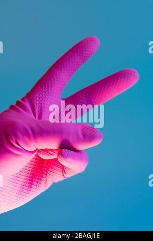 Hand with cleaning glove making fist. vertical photo. Stock Photo