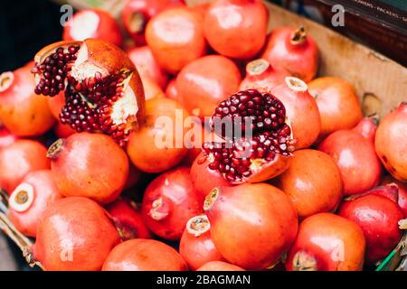 Colorful pomegranates in the box on a local farmer market in Peru Stock Photo