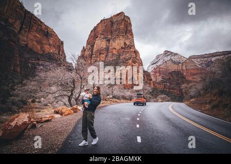 A woman with a child is walking in Zion National Park, Utah Stock Photo