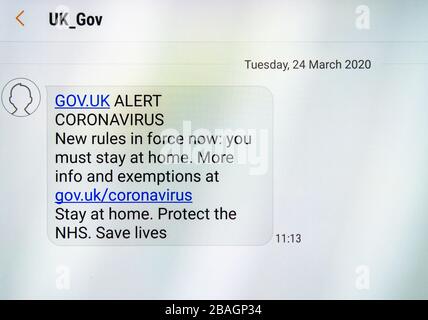 The British government's text message (SMS) with instructions to stay at home and protect the NHS during the Coronavirus pandemic Stock Photo