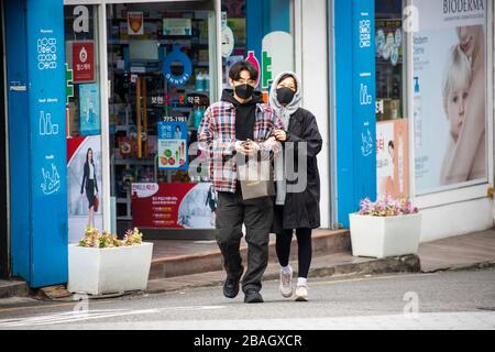 Attractive young couple wearing masks during the Coronavirus pandemic, Seoul, Korea Stock Photo