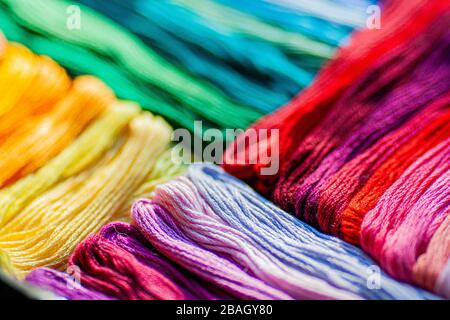 A mix of colorful mouline threads laying in diagonal color graded way, flat lay of threads , texture background. Stock Photo