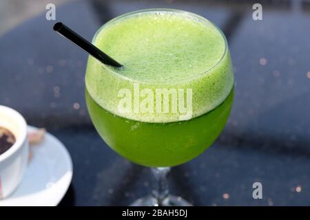 Green homemade lemonade with mint and lime. Delicious drinks based on mint and citrus fruits. Lemonade is an excellent thirst quencher. Stock Photo