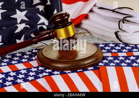 Wooden judge hammer on american flag of unfinished documents on office Justice and law Stock Photo