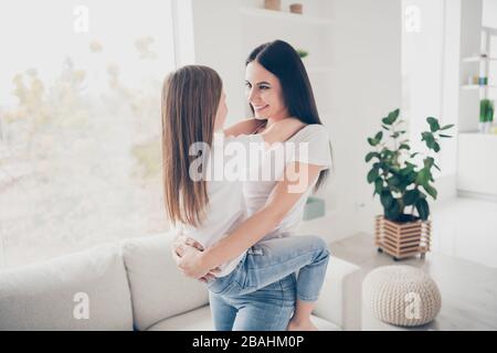 Profile photo of nice cute little girl young charming mommy holding her hands looking eyes best place in world is mom hugs spend time weekend together Stock Photo