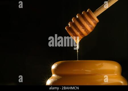 Tasty Dripping Honey pot photography - Low Key food images - high-quality food photos - Product photography Stock Photo