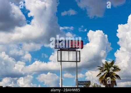 A freeway sign for an Arco Gas station in Turlock California with clouds and sky Stock Photo