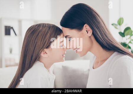 Profile photo of pretty little girl leaning heads young charming mommy affection feelings comfortable atmosphere spend time together eyes closed