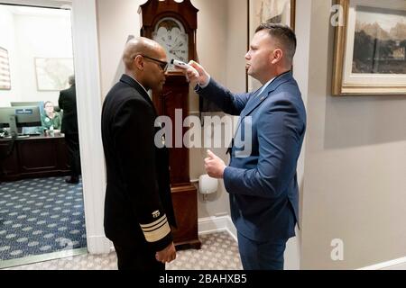 Washington, United States Of America. 22nd Mar, 2020. United States Surgeon General Dr. Jerome Adams has his temperature taken Sunday, March 22, 2020, in the West Wing of the White House. People: United States Surgeon General Dr. Jerome Adams Credit: Storms Media Group/Alamy Live News Stock Photo