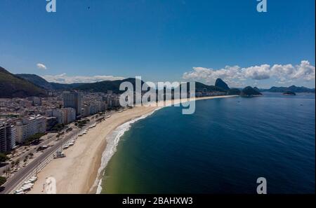 Deserted Copacabana beach and boulevard with the Sugarloaf mountain in the background during the COVID-19 Corona virus outbreak in Rio de Janeiro Stock Photo