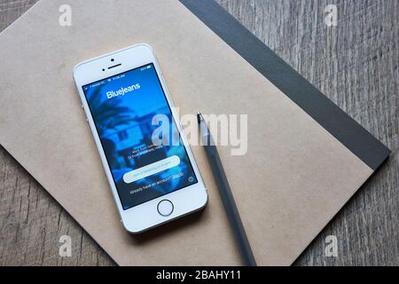 BlueJeans mobile app login screen is seen on a smartphone. The app lets users join and host interactive conference calls or engage in a town hall. Stock Photo