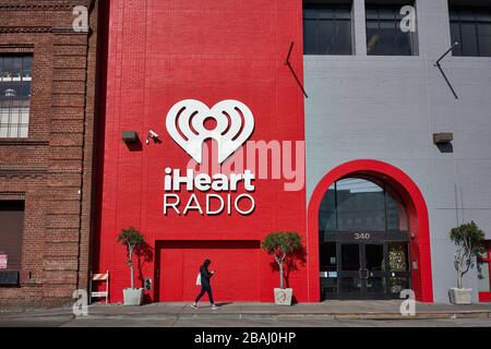 A woman walks past the iHeartMedia office in the SoMa neighborhood in San Francisco, California, on Sunday, Feb 9, 2020. Stock Photo