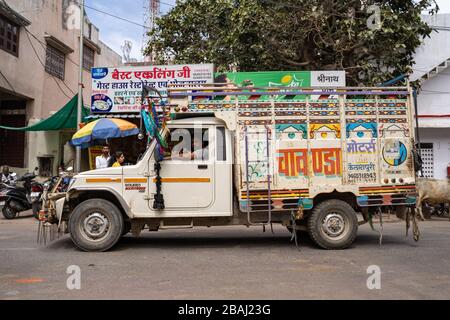 Eklingji, India - March 15, 2020: Colorful, hand painted truck passes through the village streets, delivering essential goods Stock Photo