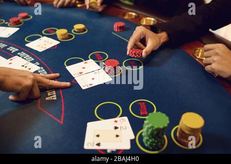 Hands of players and croupiers in the game cards Stock Photo