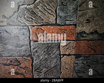 Awesome rough stone finish wall pattern in grey, brown and beige colours, India Stock Photo