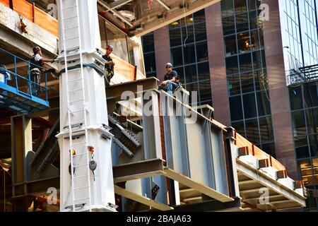 menclose up of construction workers high up on a new high rise in New York City during a break on one of the steel beams Stock Photo