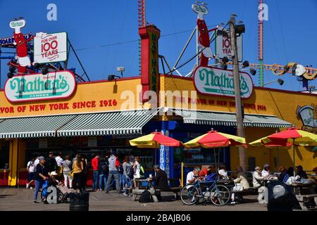 colorful concession stand of Nathan’s frankfurter on the boardwalk of Coney Island New York Stock Photo