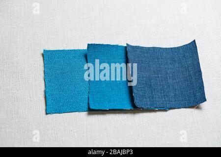 square pieces of multi-colored fabric laid out on a gray background Stock Photo