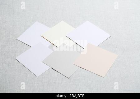 square pieces of multi-colored fabric laid out on a gray background Stock Photo