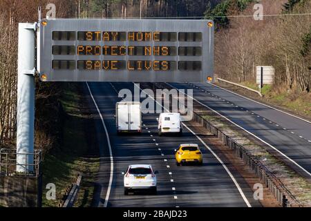 East Lothian, Scotland, UK. 28 March, 2020. Coronavirus lockdown roadside warning sign with message STAY HOME PROTECT NHS SAVE LIVES on A1 highway in East Lothian. Iain Masterton/Alamy Live News Stock Photo