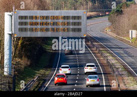 East Lothian, Scotland, UK. 28 March, 2020. Coronavirus lockdown roadside warning sign with message STAY HOME PROTECT NHS SAVE LIVES on A1 highway in East Lothian. Iain Masterton/Alamy Live News Stock Photo