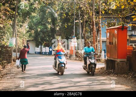 Goa, India - February 14, 2020: People Riding On Scooters Motorcycle On Street. Stock Photo
