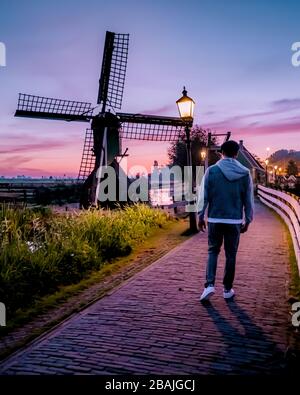 Sunrise Zaanse Schand Dutch windmill village, Windmill village Zaanse Schans, green wooden house at the windmill village zaanse schans Netherlands Stock Photo