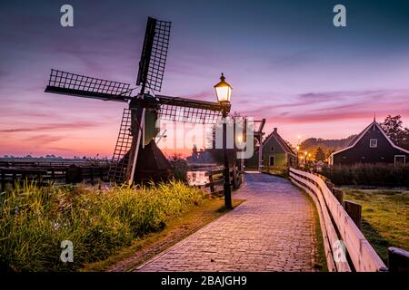 Sunrise Zaanse Schand Dutch windmill village, Windmill village Zaanse Schans, green wooden house at the windmill village zaanse schans Netherlands Stock Photo