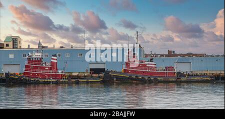 Two Red Tugboats in Harbor at Dusk Stock Photo