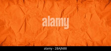 Old orange crumpled paper texture background. Wallpaper banner Stock Photo
