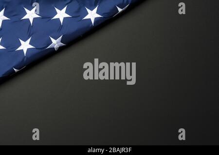 American flag lying on black grainy background Stock Photo
