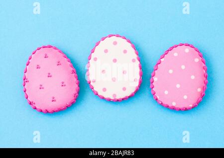 Easter background concept. Polka dot easter egg cookies on a blue background. Top view. Stock Photo