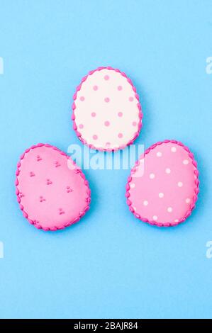 Easter background concept. Polka dot easter egg cookies on a blue background. Top view. Stock Photo