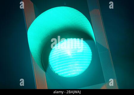 green traffic light on road at twilight united kingdom Stock Photo