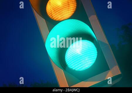 green traffic light on road at twilight united kingdom Stock Photo