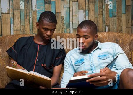 two black african seriously student studying their school work against their exam. Stock Photo