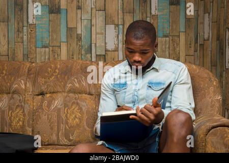 young african student seriously studying his note Stock Photo