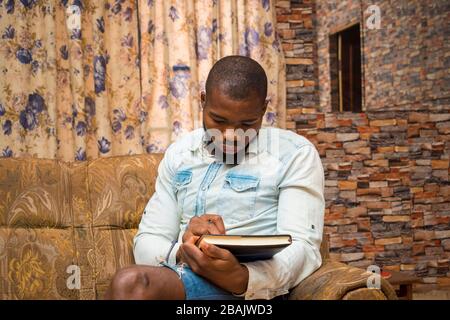 young african student seriously studying his note Stock Photo
