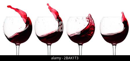 Splashes of red wine in a glasses isolated on a white background. Stock Photo