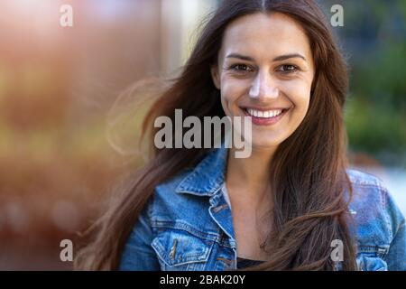 Portrait of young woman in urban area Stock Photo