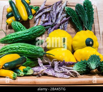 group of asian vegetables on wooden cutting board reflected in mirror Stock Photo