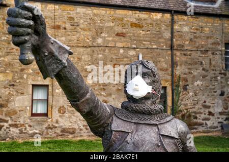 Alexandra Road, Elgin, Moray, UK. 28th Mar, 2020. UK. This is the statue for Alexander Stewart, Earl of Buchan, Alasdair Mór mac an Rígh, and called the Wolf of Badenoch (1343 - 20 June 1405), was the third surviving son of King Robert II of Scotland and youngest by his first wife, Elizabeth Mure of Rowallan. He has adorned his mask to fight COVID-19. Credit: JASPERIMAGE/Alamy Live News Stock Photo