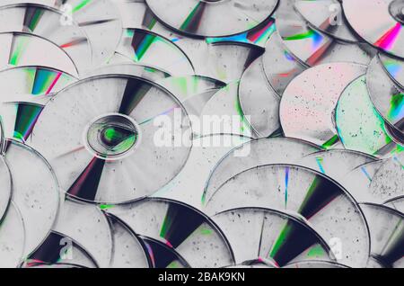 Group of old CD DVD compact optical disk storage medium with dust and scratches. Abstract grunge processing Stock Photo
