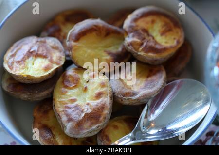 Traditional Finnish summer cottage food every Finn loves to enjoy during midsummer fest and summer in general. Delicious homemade oven potatoes. Stock Photo