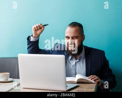 Euphoric happy businessman scream read good online news celebrating business success, great result watching game on laptop, excited by victory, bettin Stock Photo