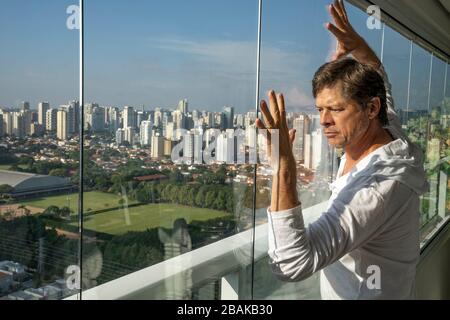 A desperate mature man at home. Frustrated older mature retired man feeling upset desperate talking, stressed sad middle-aged male depressed. Stock Photo