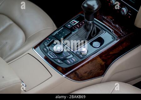 Automatic transmission gear, car interior. Automatic gear stick of a modern car, interior details, close up. Car detailing. Transmission lever Stock Photo