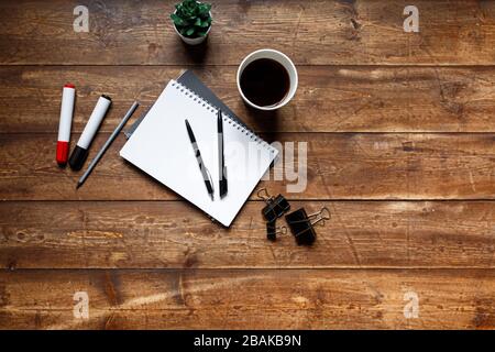 written wooden table, on the table a notebook and a notebook with a ballpoint pen Stock Photo