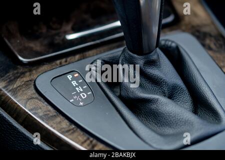 Automatic transmission gear, car interior. Automatic gear stick of a modern car, interior details, close up. Car detailing. Transmission lever Stock Photo