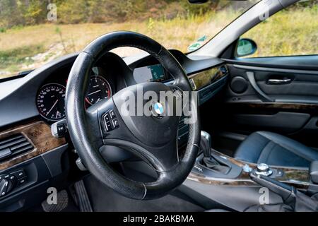 BMW steering wheel close up - detailed photo of instrument cluster, switches, commands, dashboard inside german iconic car Stock Photo